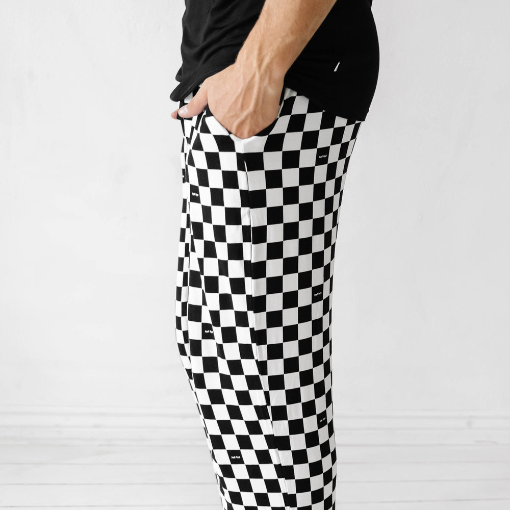 Click to see full screen - close up profile view of a man with his hands in his pockets wearing Cool Checks printed men's pajama pants