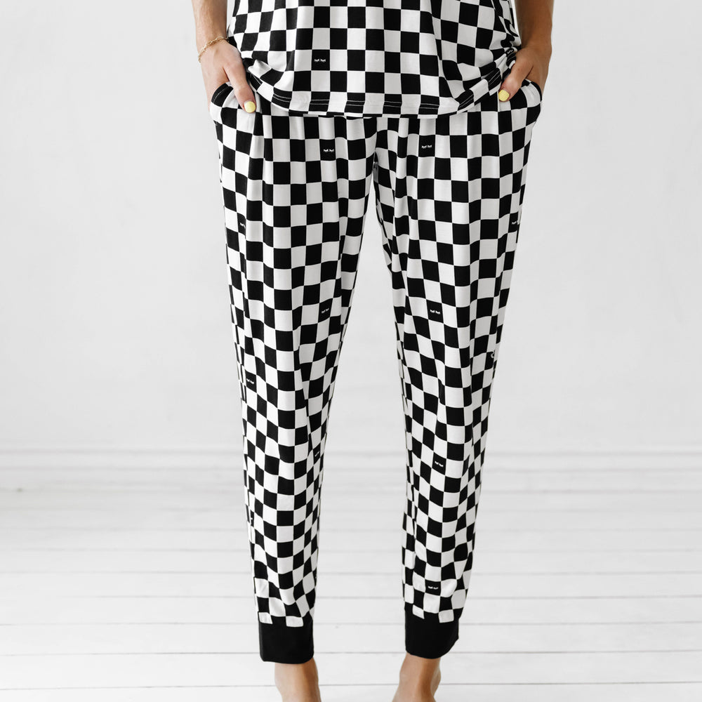 Close up image of a woman with her hands in her pockets wearing Cool Checks printed women's pajama bottoms