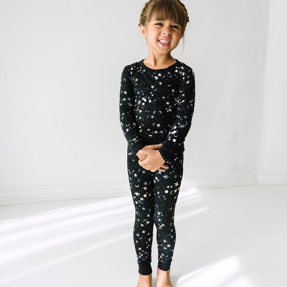 Child wearing a Counting Stars printed two piece pajama set