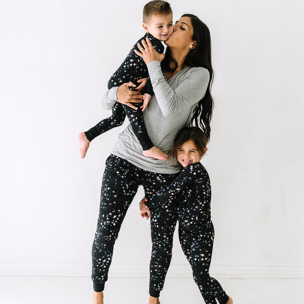 Family of three wearing matching Counting Stars printed pajamas