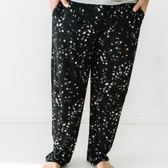 Close up image of a man wearing Counting Stars printed men's pajama pants
