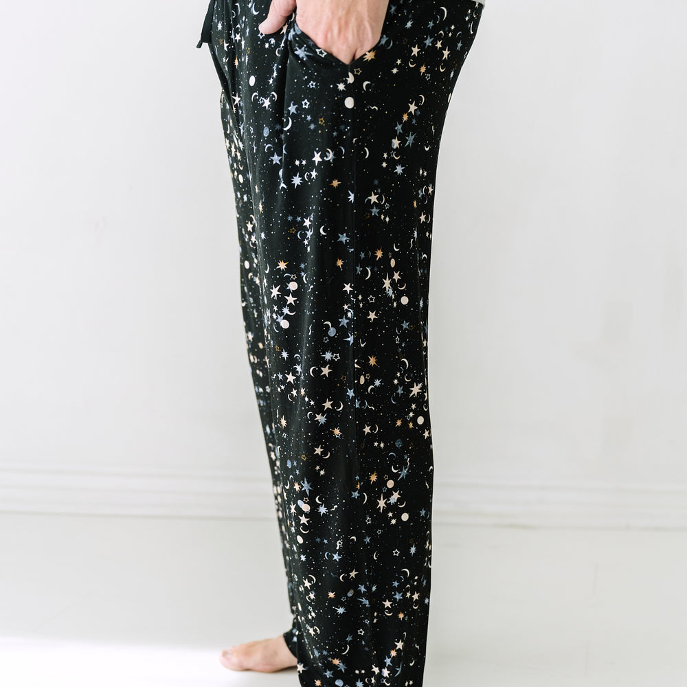 Close up side view image of a man wearing Counting Stars printed men's pajama pants