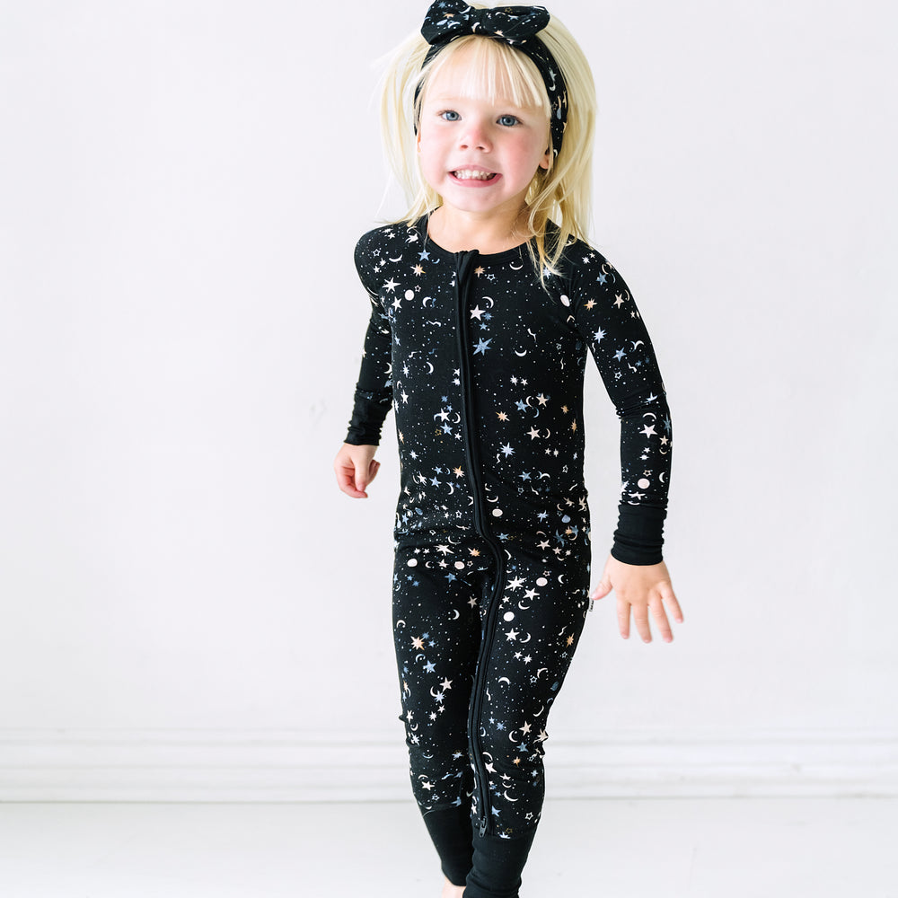 Child jumping wearing a Counting Stars printed zippy