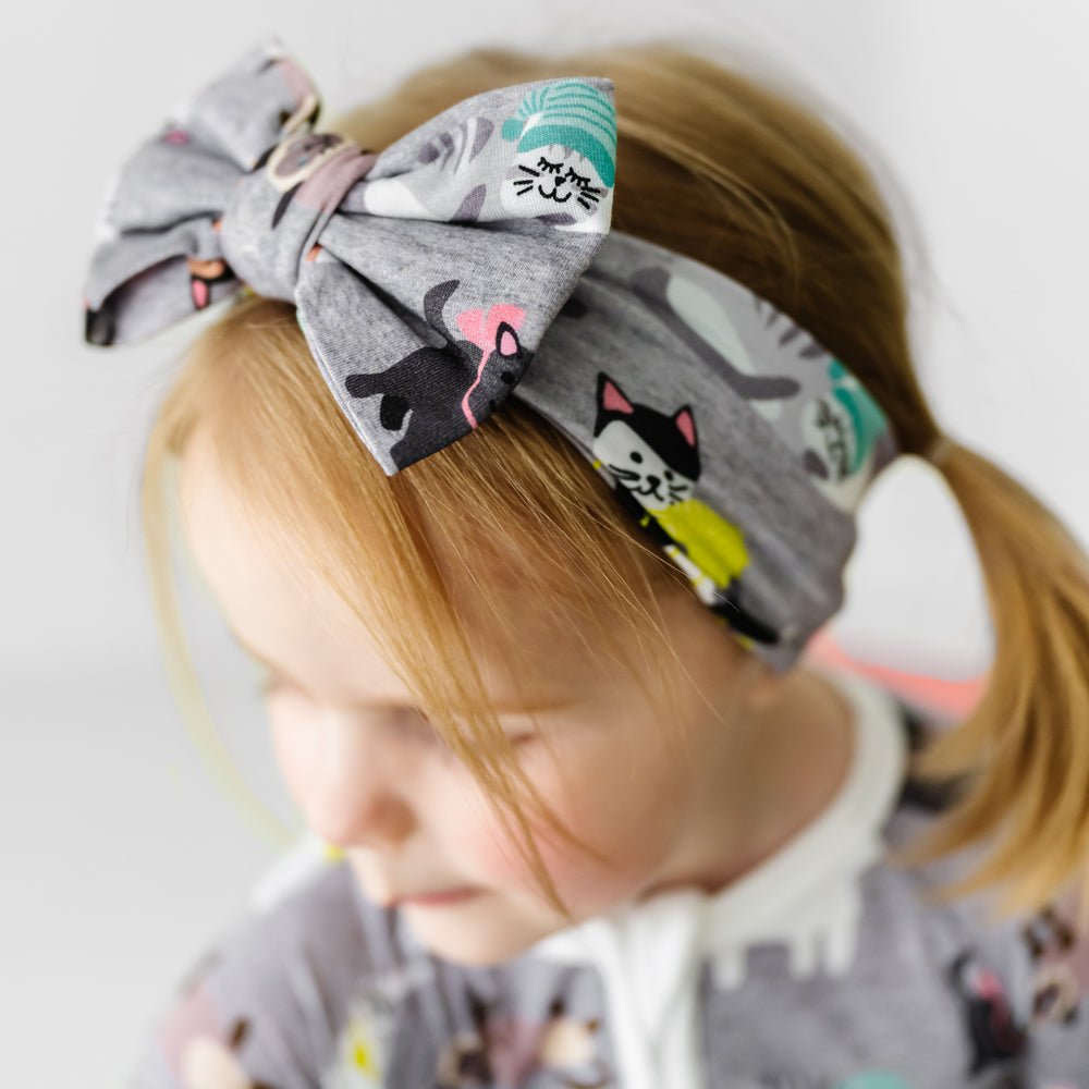 Alternate close up image of a child wearing a Cozy Cats luxe bow headband