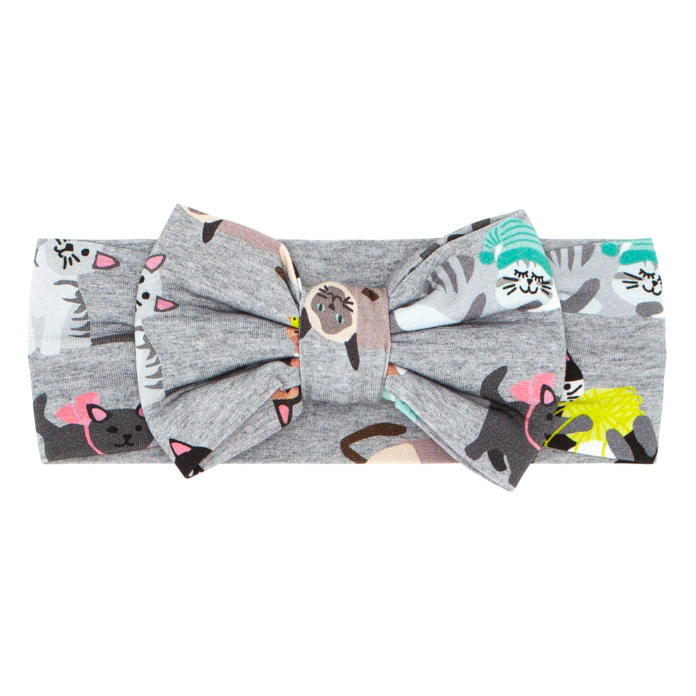 Flat lay image of a Cozy Cats luxe bow headband