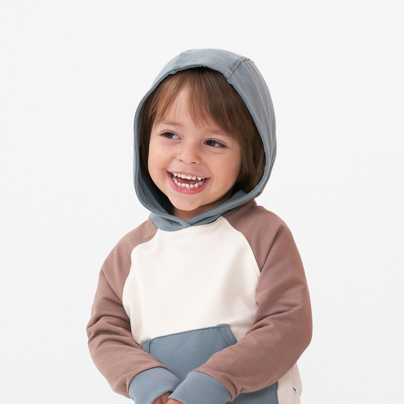 Close up image of a child wearing a Colorblock pullover hoodie with the hood up