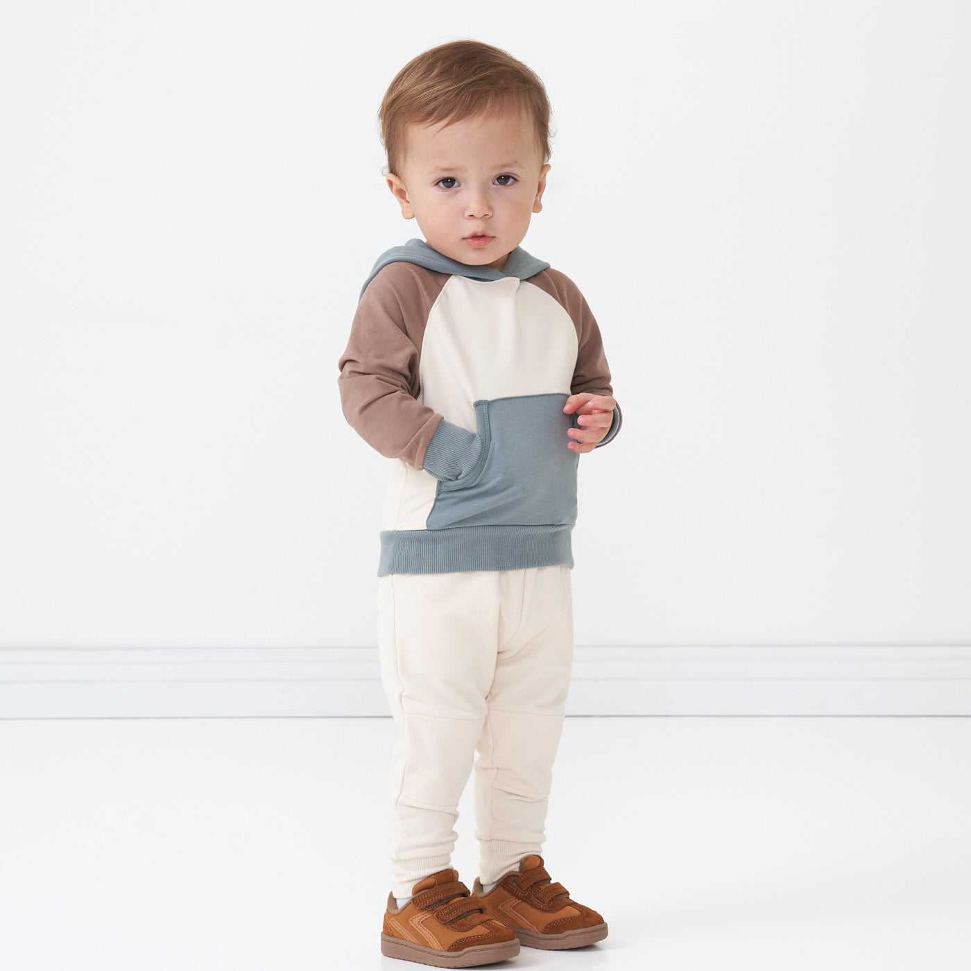 Child wearing a Colorblock pullover hoodie paired with Cream joggers