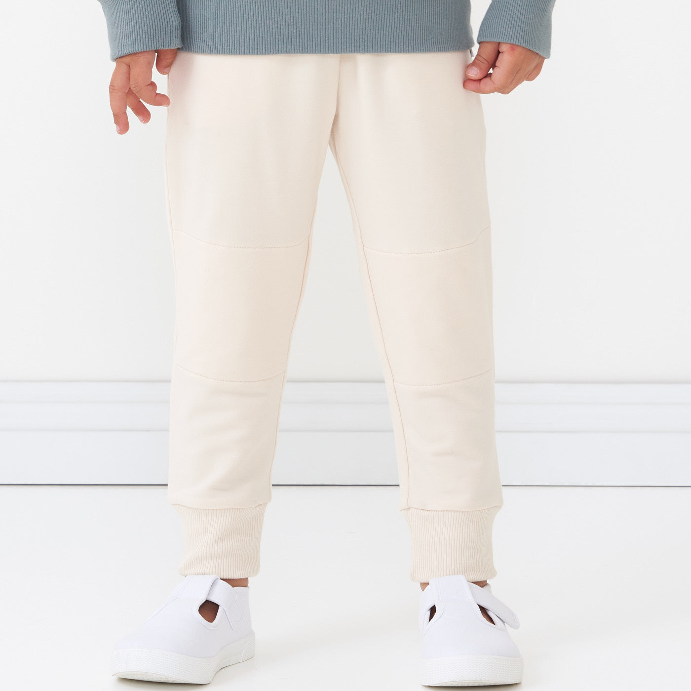 Alternate close up image of a child wearing Cream joggers