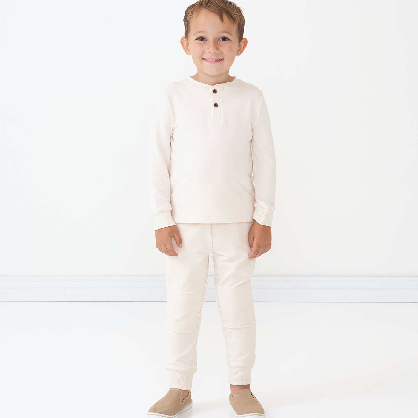 Child wearing a Cream henley tee and matching joggers