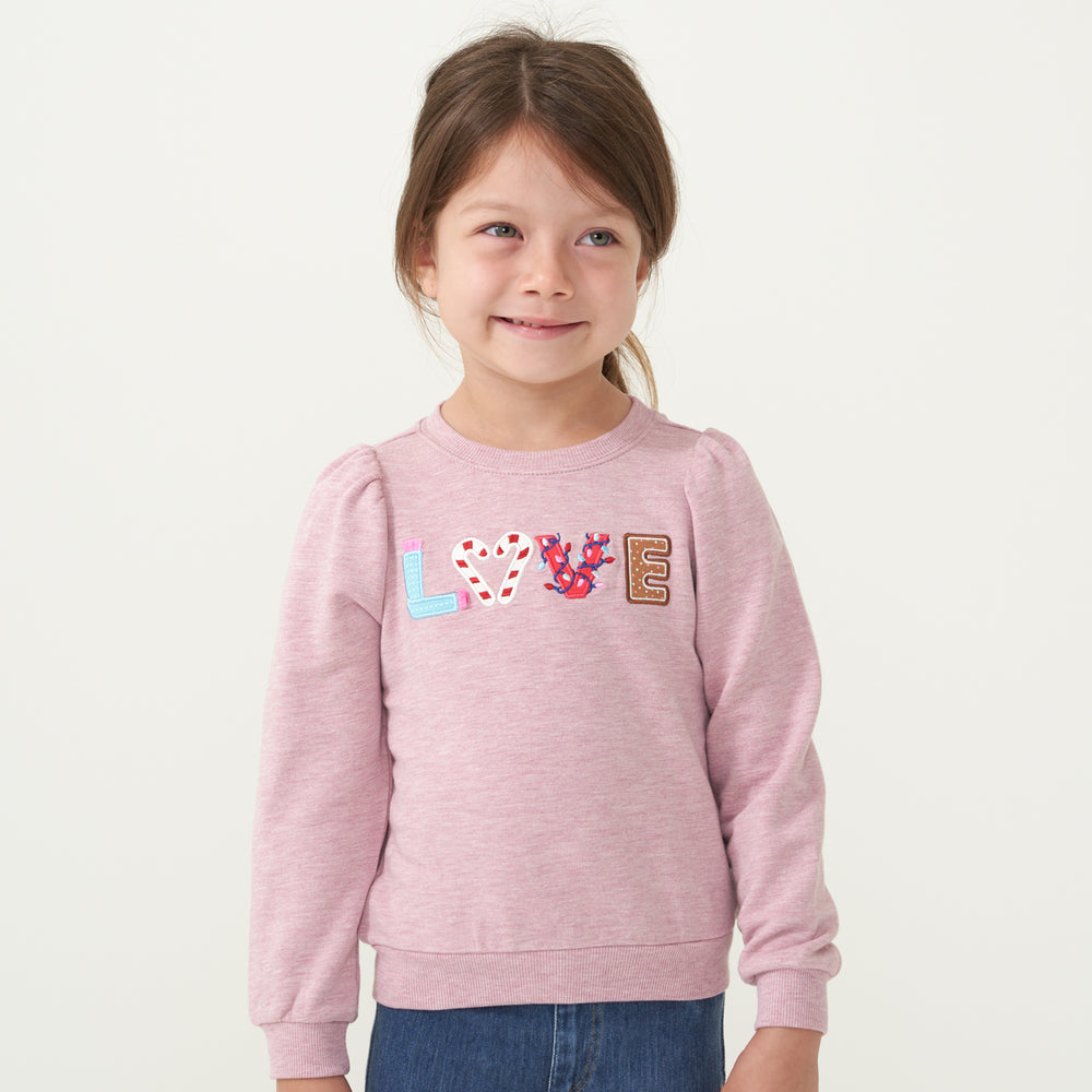 Child wearing a Heather Mauve Love puff sleeve crewneck