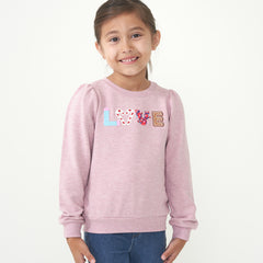 Child wearing a Heather Mauve Love puff sleeve crewneck