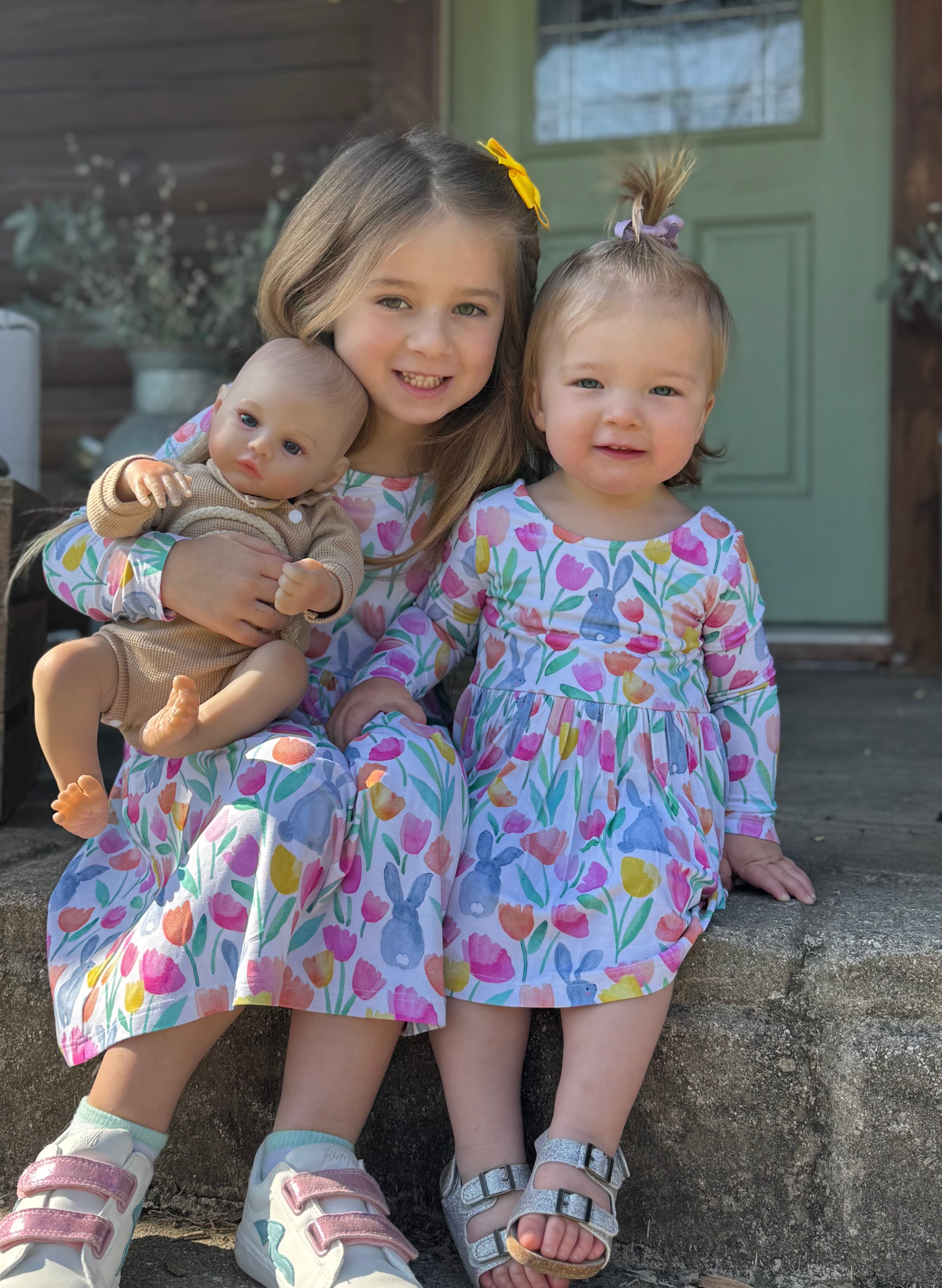 Two siblings wearing matching Garden Hop dresses