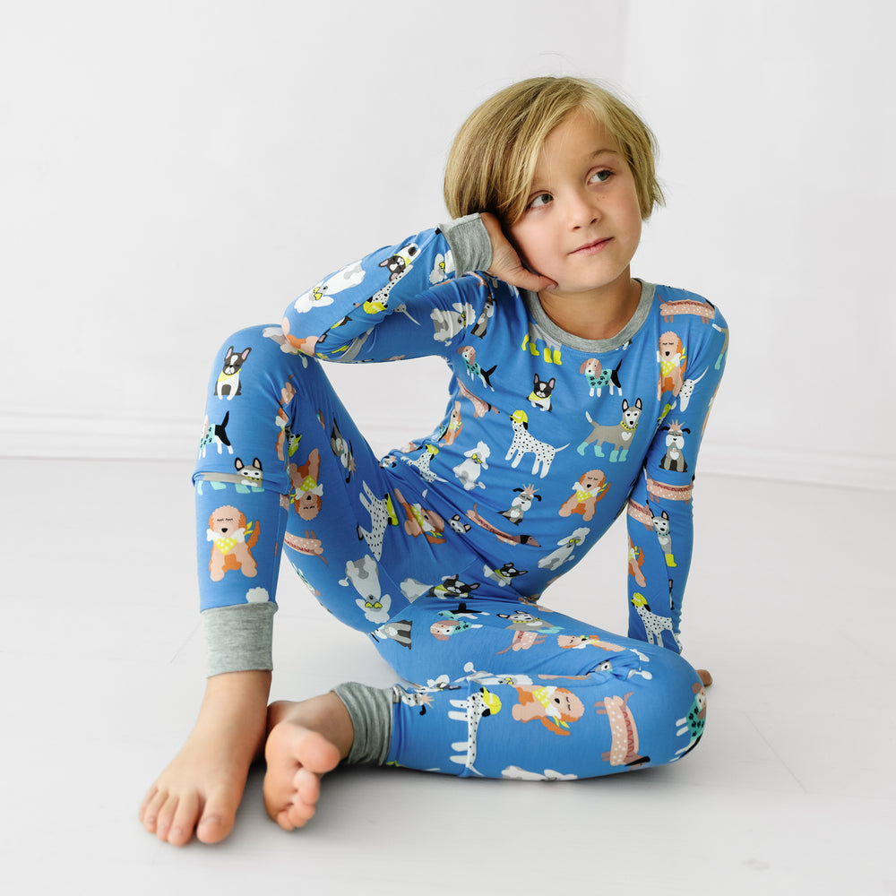 Alternate image of a child sitting on the groundwearing a Dapper Dogs two-piece pajama set