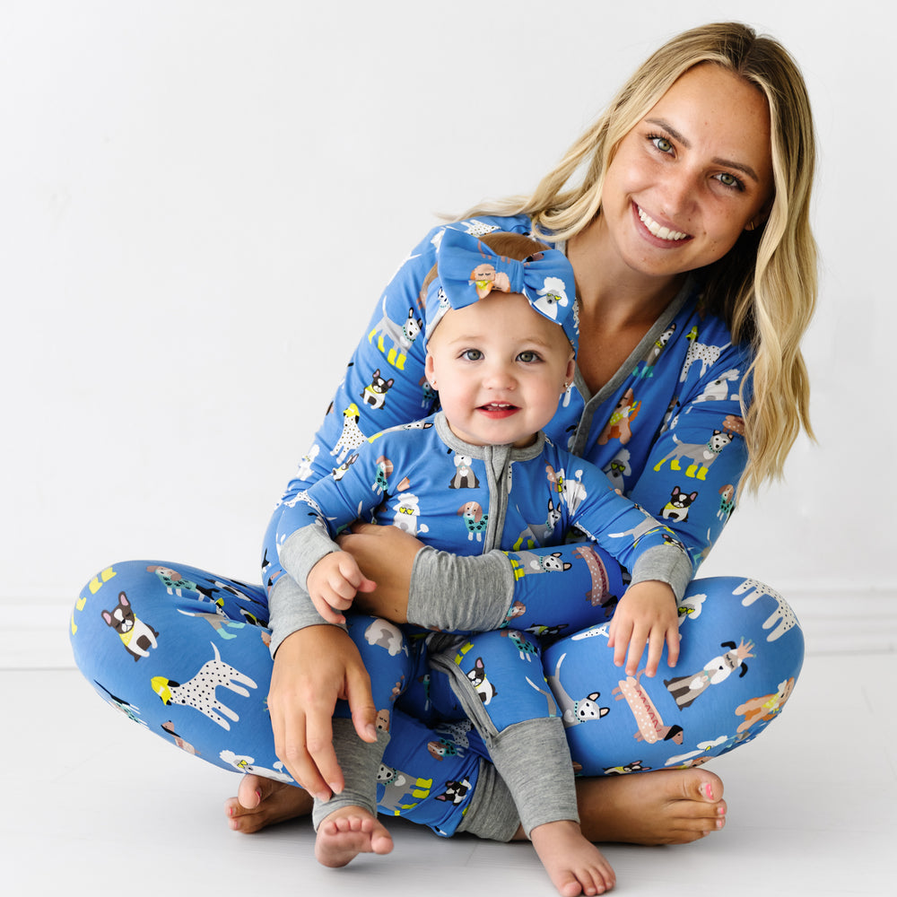 Child wearing a Dapper Dogs luxe bow headband and wearing matching Dapper Dogs pajamas with their mother