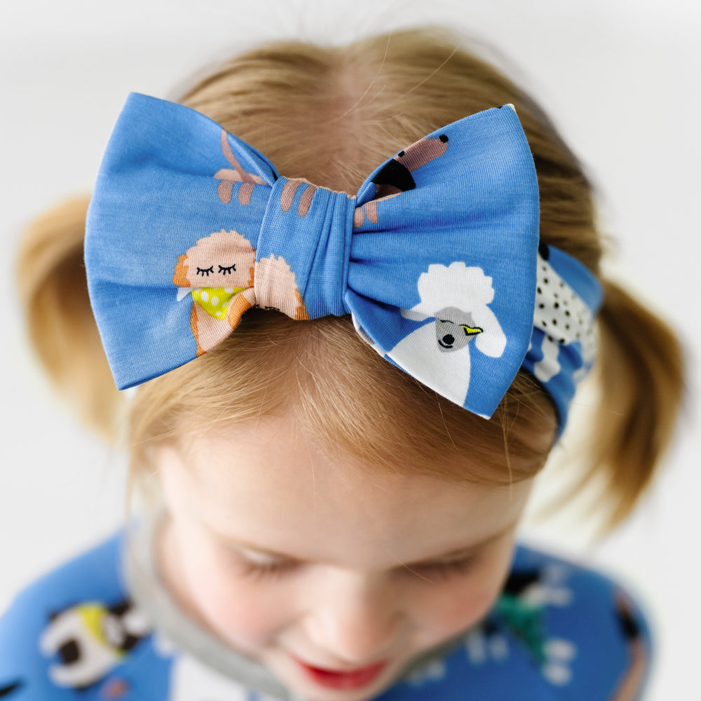 Close up image of a child wearing a Dapper Dogs luxe bow headband