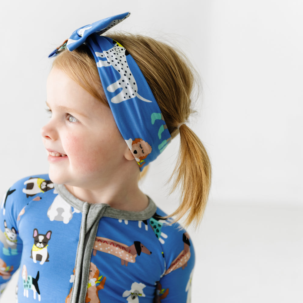 Side view image of a child wearing a Dapper Dogs luxe bow headband and matching zippy