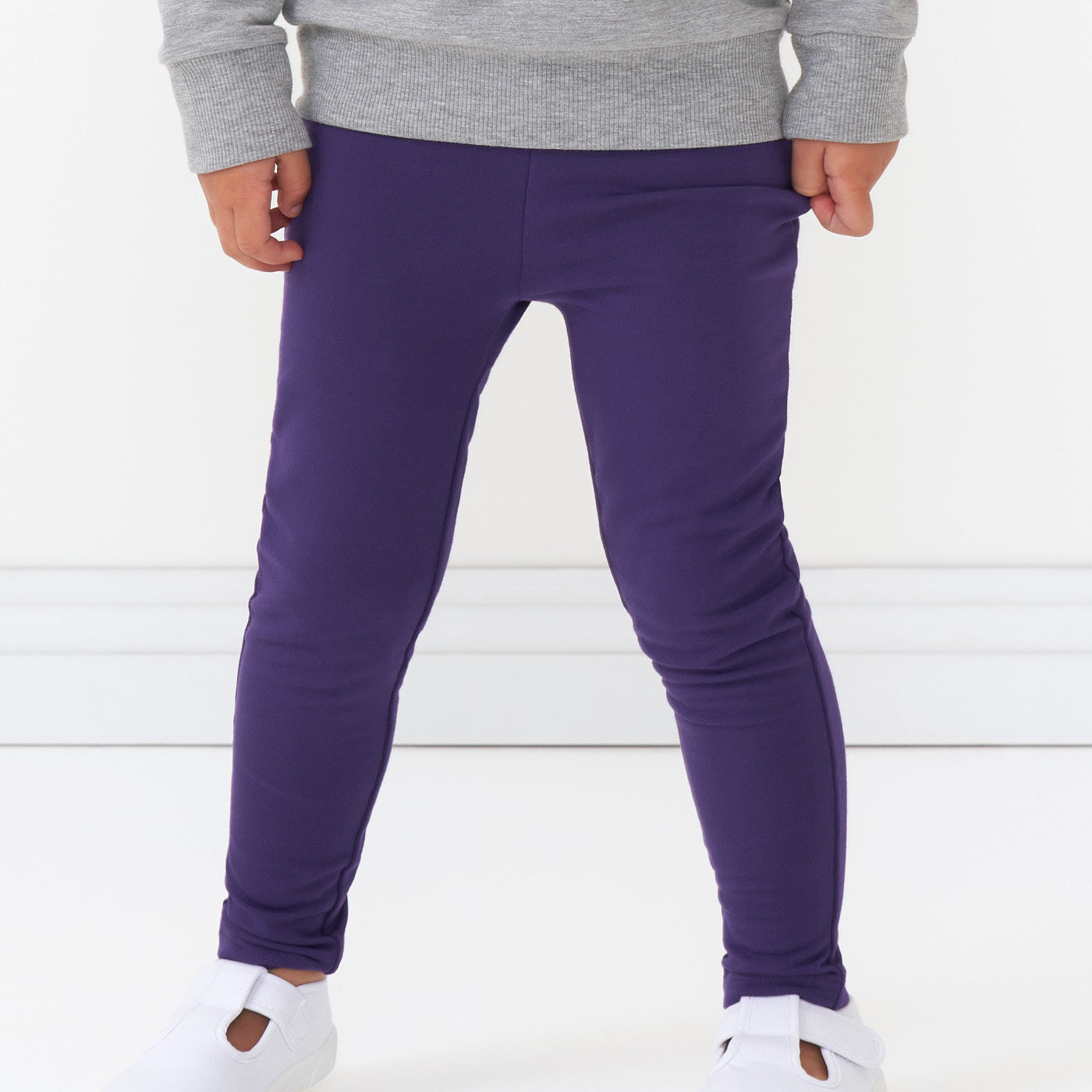 Close up image of a child wearing Deep Amethyst cozy leggings