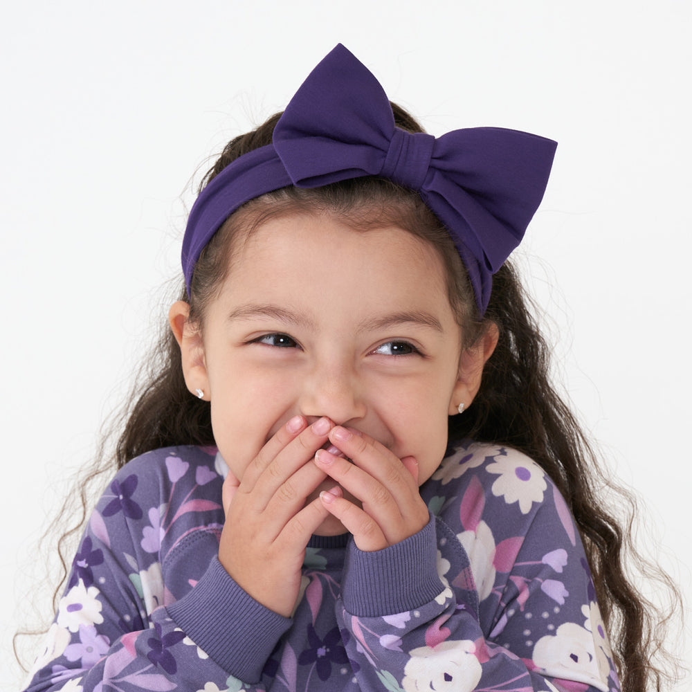 Child wearing a Deep Amethyst luxe bow headband and coordinating Sugar Plum Floral puff sleeve crewneck
