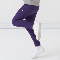 Side view image of a child wearing Deep Amethyst ribbed lettuce leggings