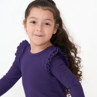 Alternate close up image of a child wearing a Deep Amethyst ribbed flutter lettuce tee
