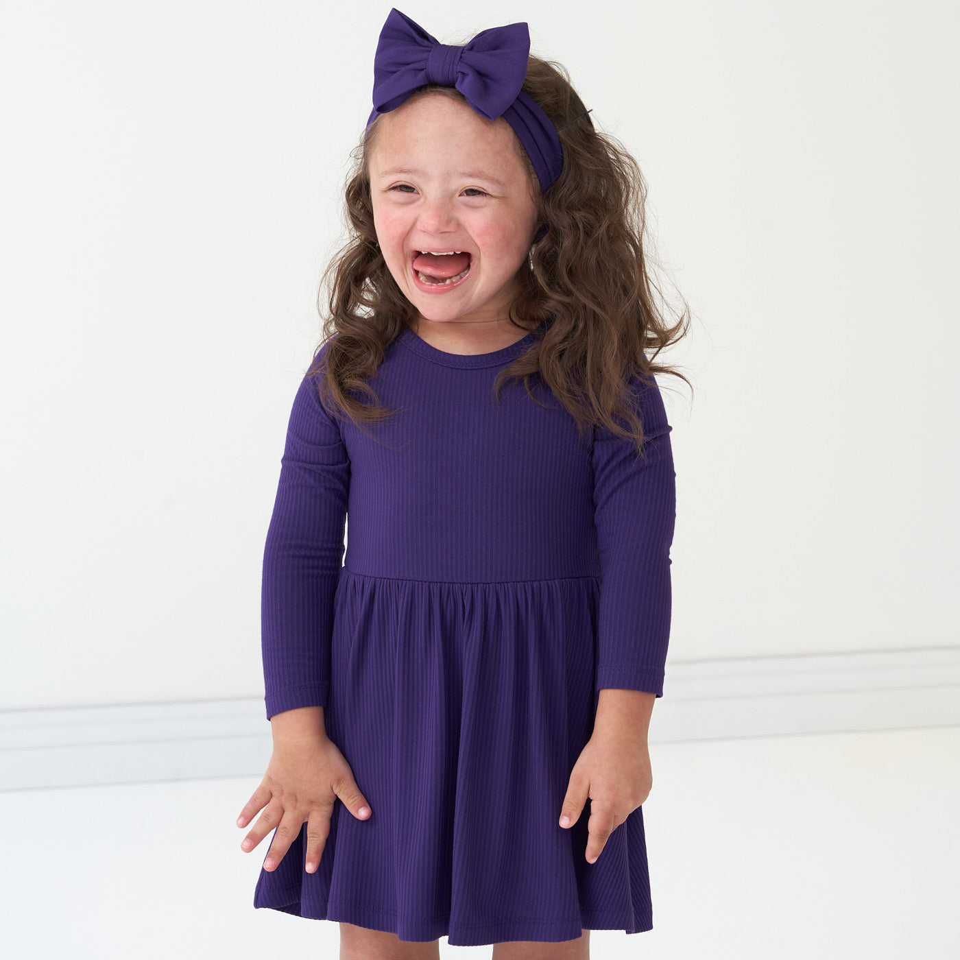 Alternate image of a child wearing a Deep Amethyst ribbed twirl dress and matching luxe bow headband