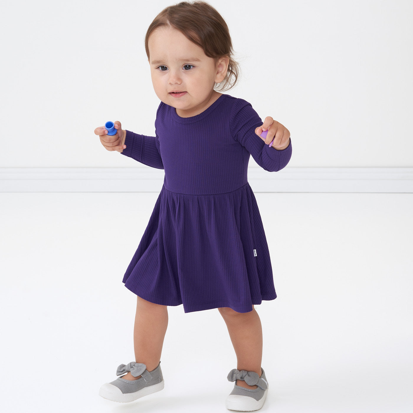 Child wearing a Deep Amethyst ribbed twirl dress with bodysuit