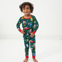 Child wearing a Disney Christmas Party two piece pajama set