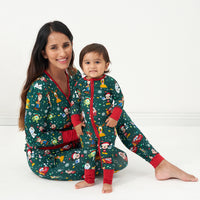 Alternate image of a mother and child wearing matching Disney Christmas Party pajamas
