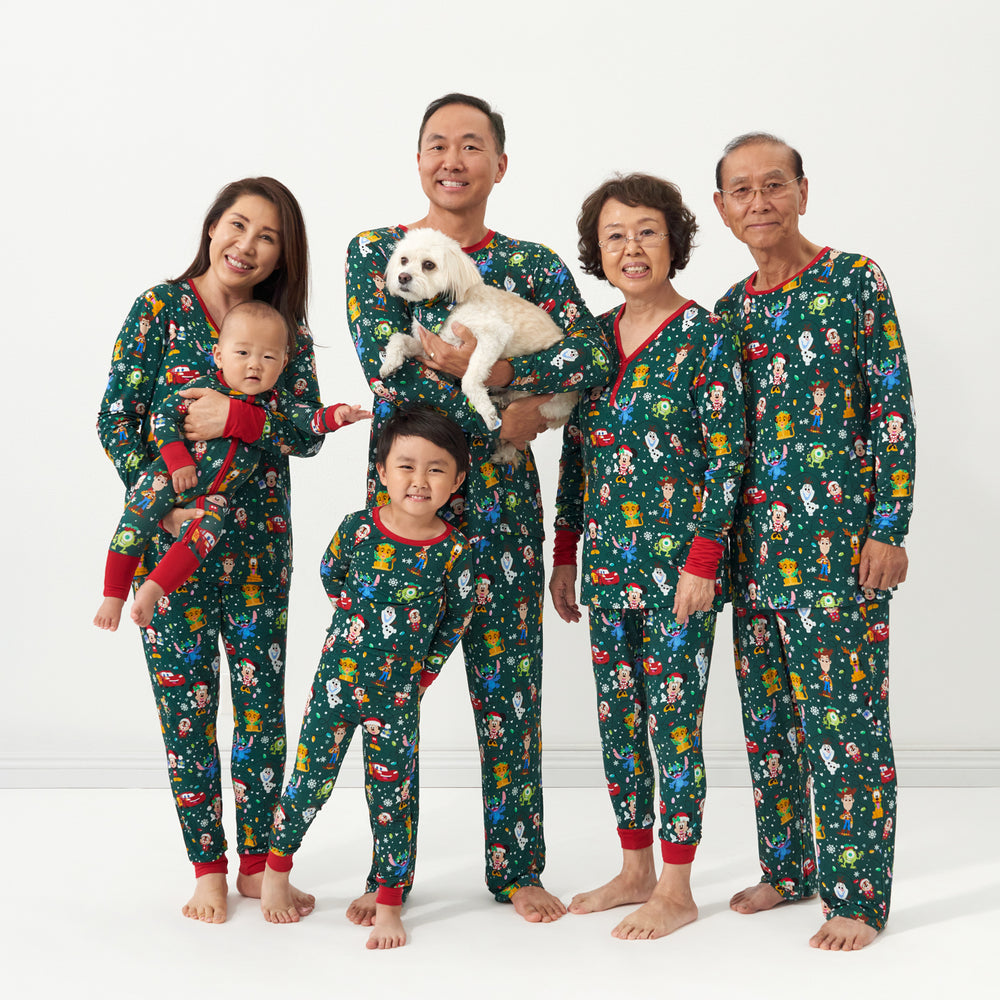 Family and dog wearing matching Disney Christmas Party pajamas and pet bandana