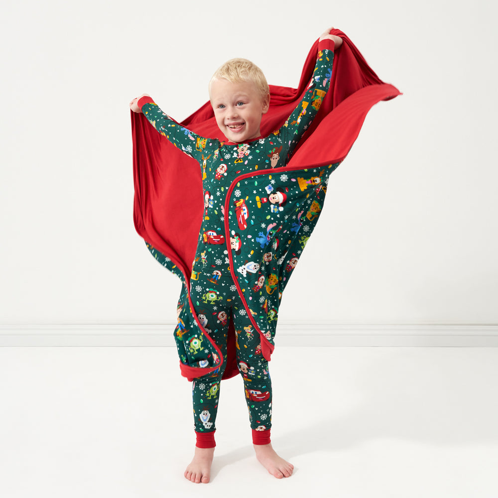 Child shaking out a Disney Christmas Party Large Cloud Blanket