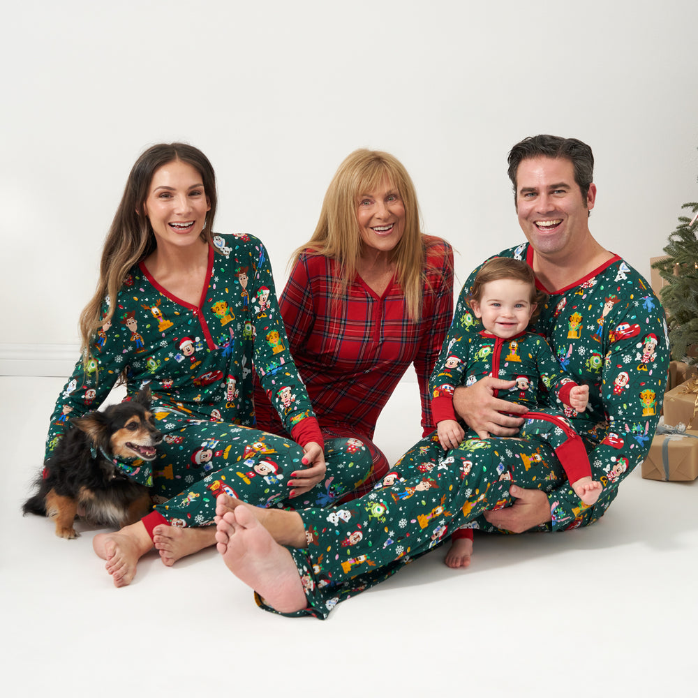 Family and dog wearing coordinating holiday pajamas and pet bandana