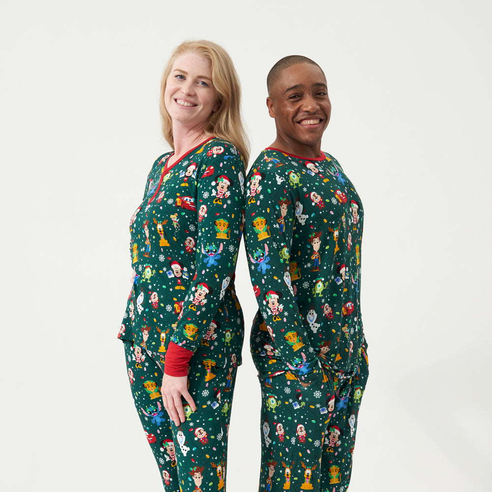 Alternate image of a man and woman wearing matching Disney Christmas Party adult pajamas