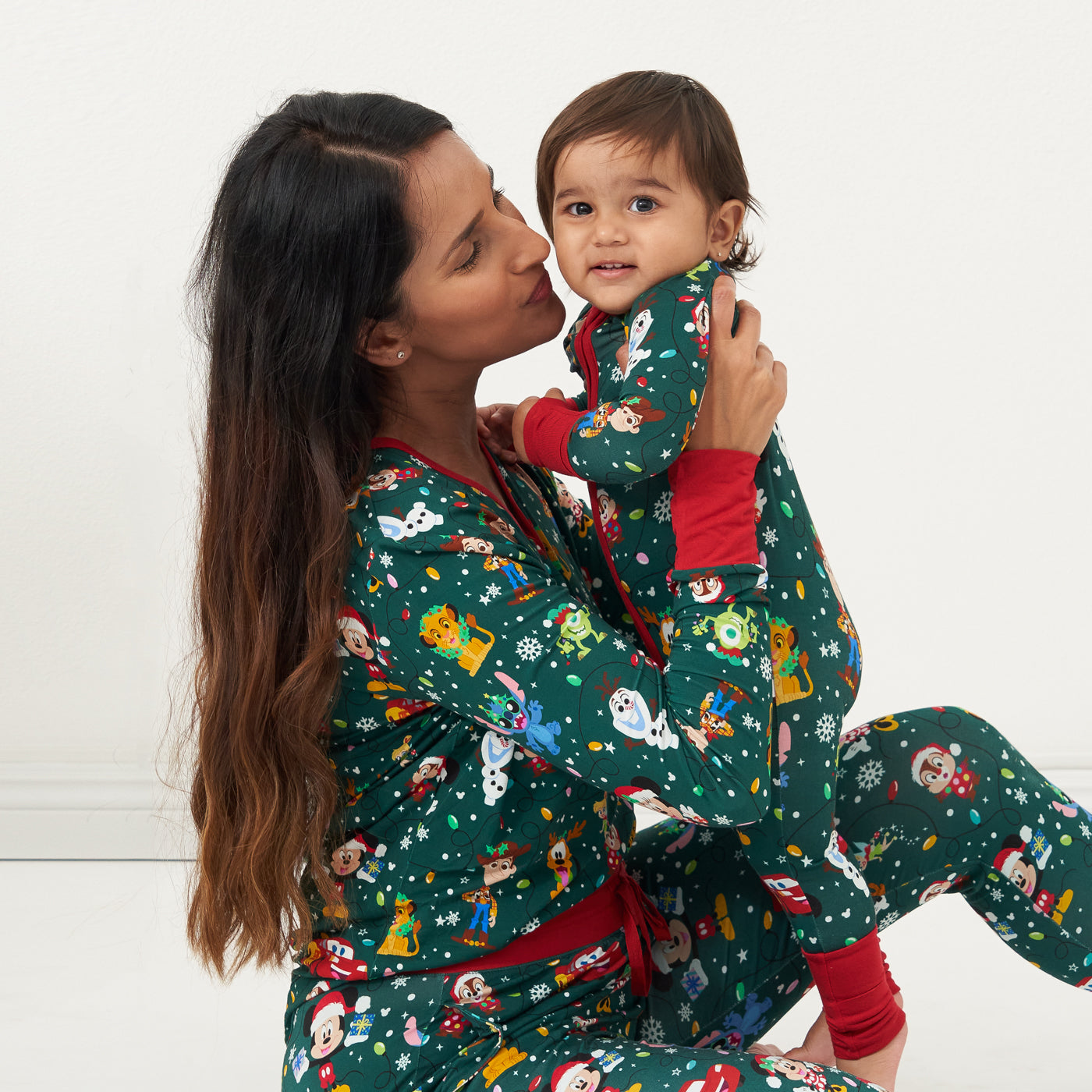 Mother and child wearing matching Disney Christmas Party pajamas