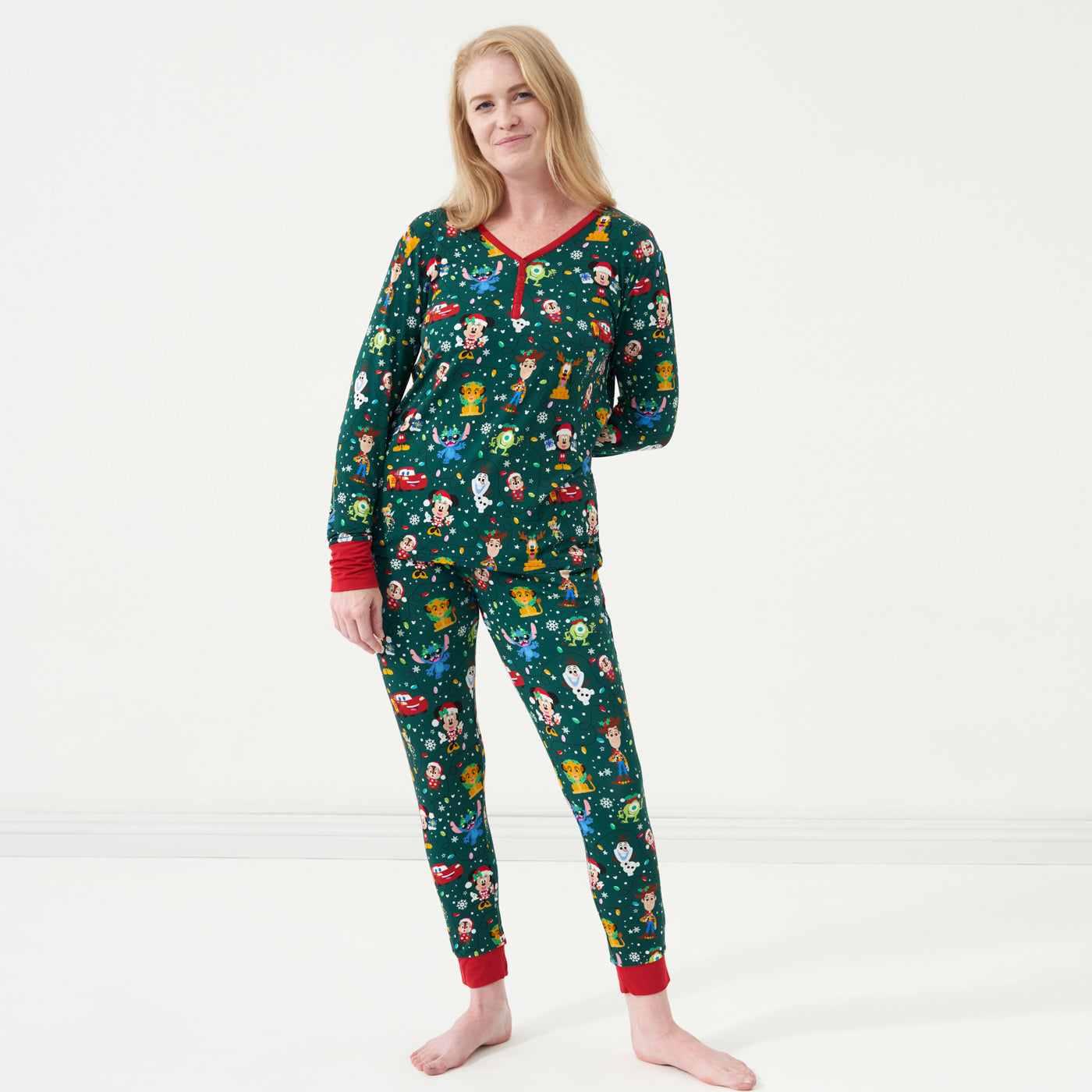 Woman wearing a Disney Christmas Party women's pajama top and matching pants