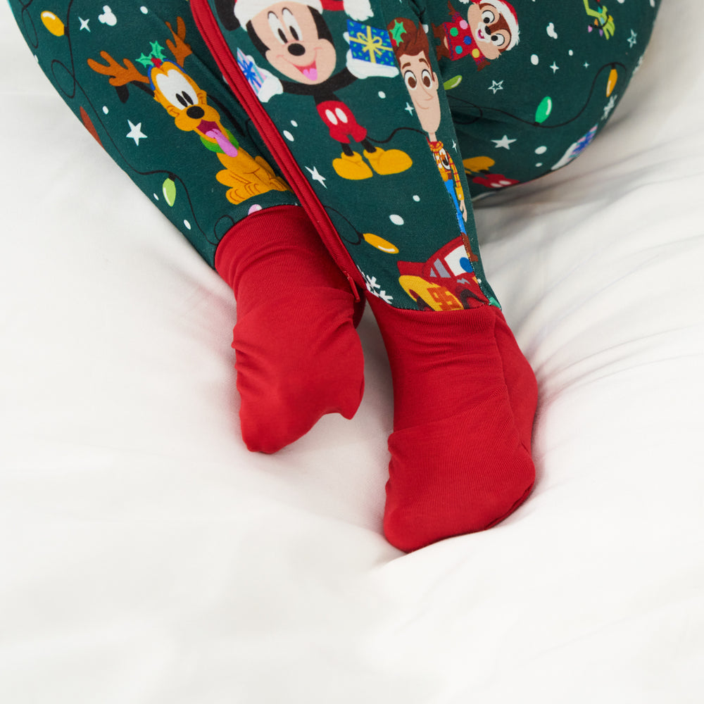 Close up image of a child wearing a Disney Christmas Party zippy highlighting the fold over foot cuffs