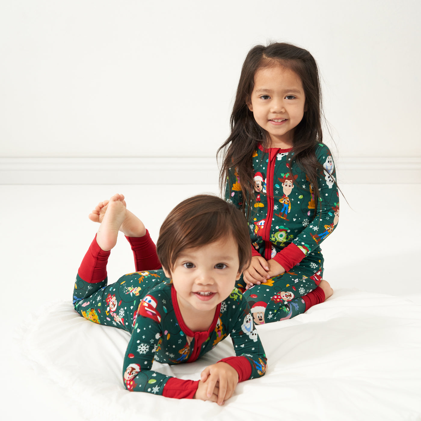 Two children wearing matching Disney Christmas Party zippies