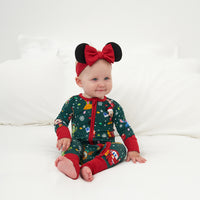 Child wearing a Disney Christmas Party zippy and coordinating luxe bow headband