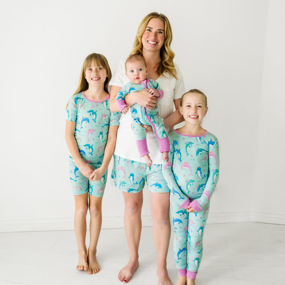 Family of four wearing matching Dolphin Dance pajamas