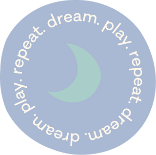 A periwinkle circular badge with the text "dream. play. repeat." around the edges and a teal crescent moon in the center