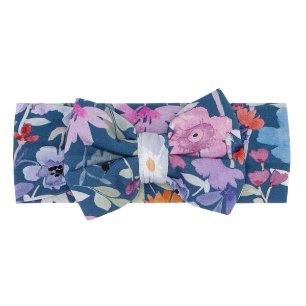 Flat lay image of Dusk Blooms luxe bow headband