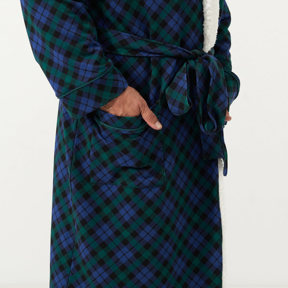 Close up image of a man wearing an Emerald Plaid cozy robe detailing the pocket