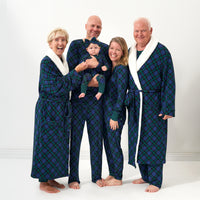 Family wearing matching Emerald Plaid pajamas and cozy robes