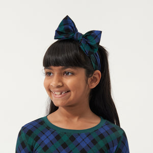 Child wearing an Emerald Plaid luxe bow headband