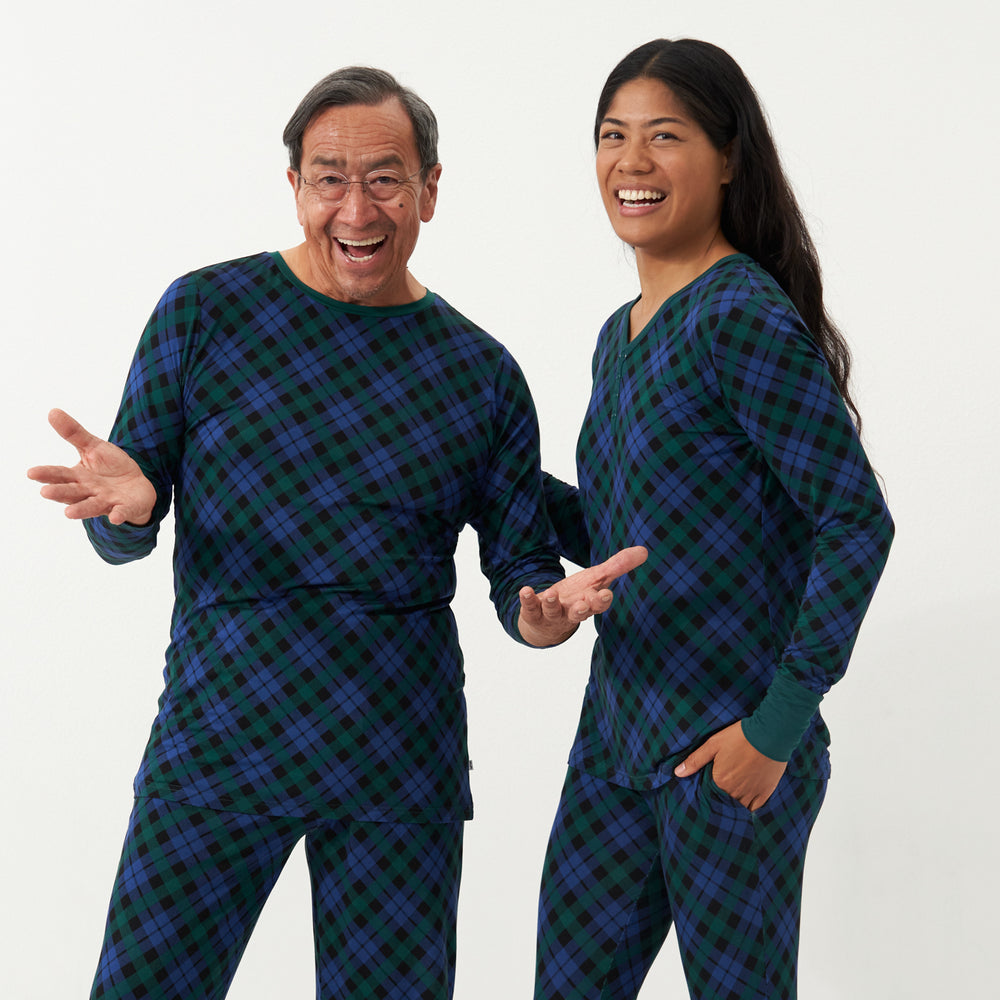 Woman and man wearing matching Emerald Plaid pajamas