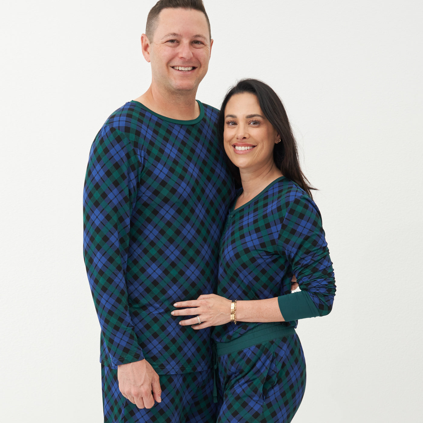 Alternate image of a woman and man wearing matching Emerald Plaid pajamas
