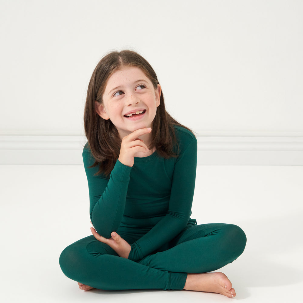 Alternate image of a child sitting on the ground wearing an Emerald two-piece pajama set