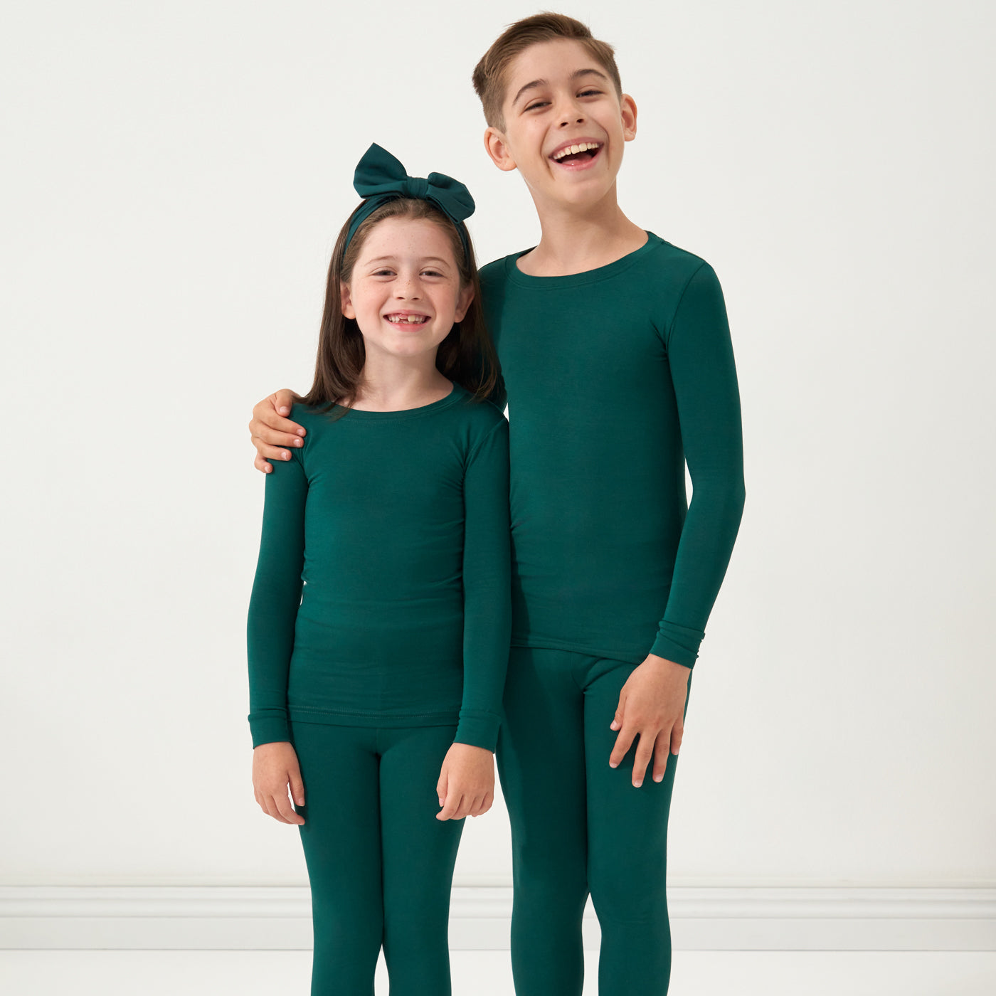 Two children wearing matching Emerald two-piece pajama sets