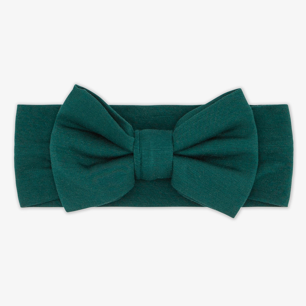 Flat lay image of the Emerald Luxe Bow Headband