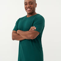 Close up image of a man wearing an Emerald men's short sleeve pajama top and coordinating pants