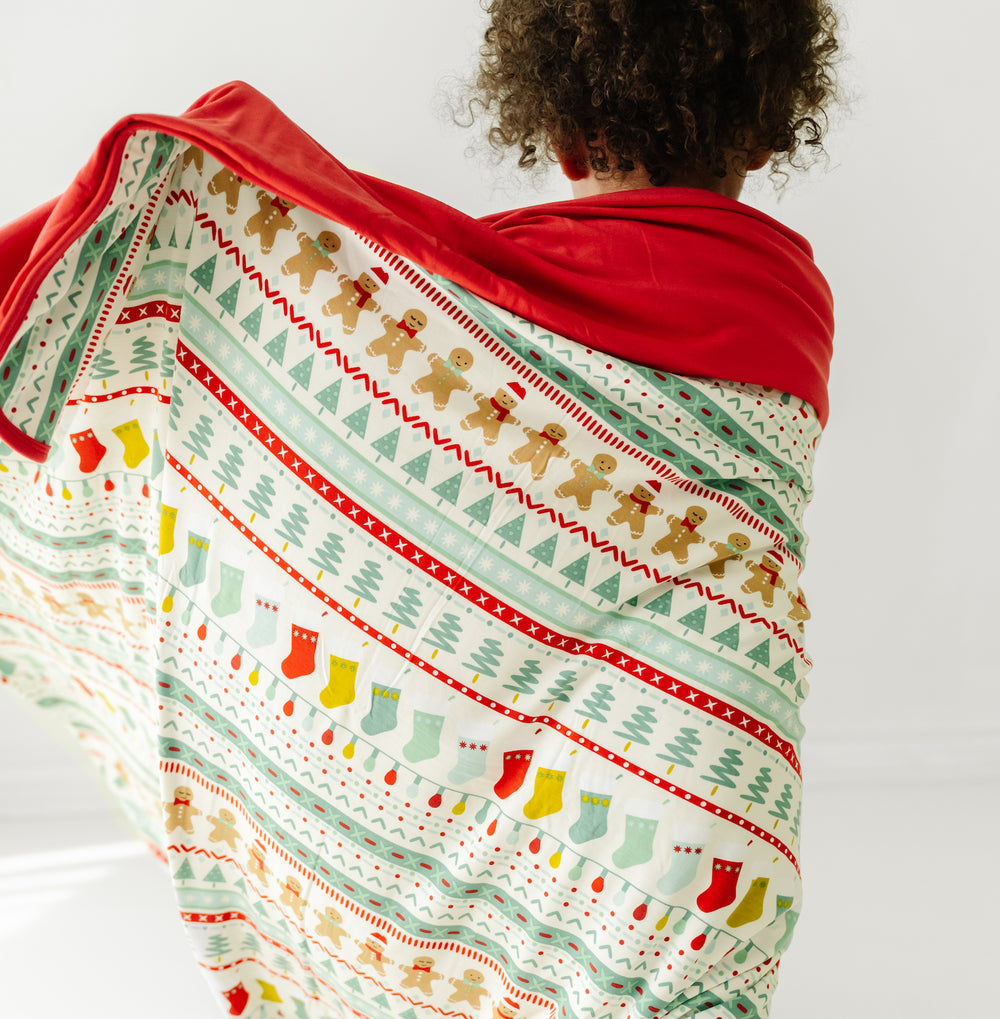 Back view image of a child wrapped up in a Fair Isle large cloud blanket